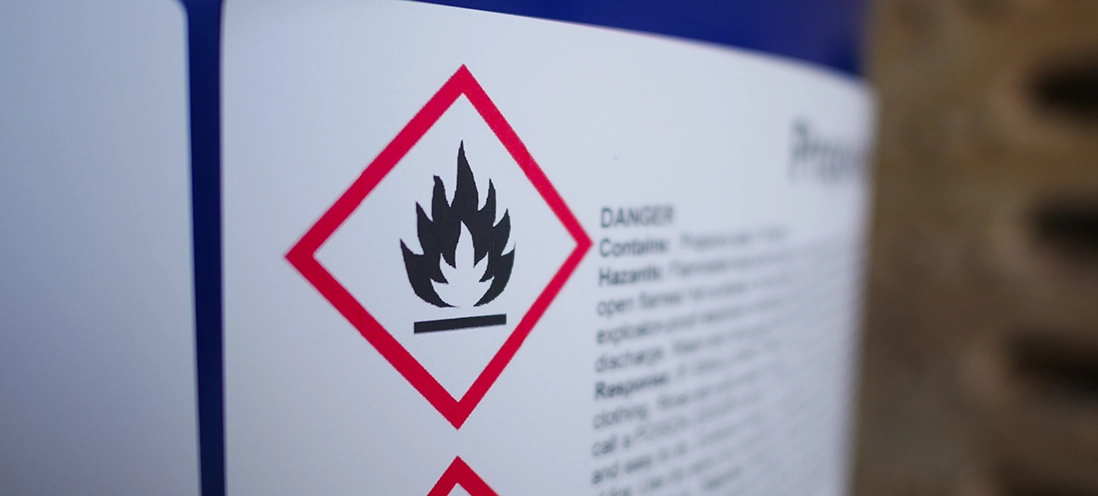 Hazard label on a bottle of chemicals.